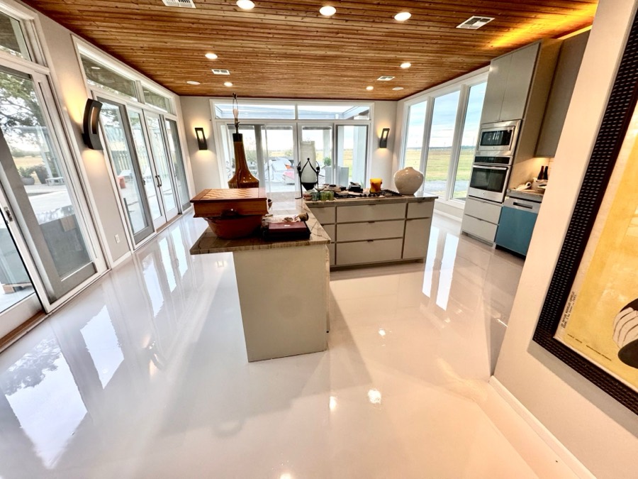 Glossy white epoxy floor in a modern kitchen