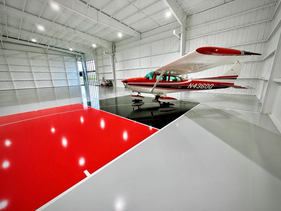 Red and black court inside an airplane hangar