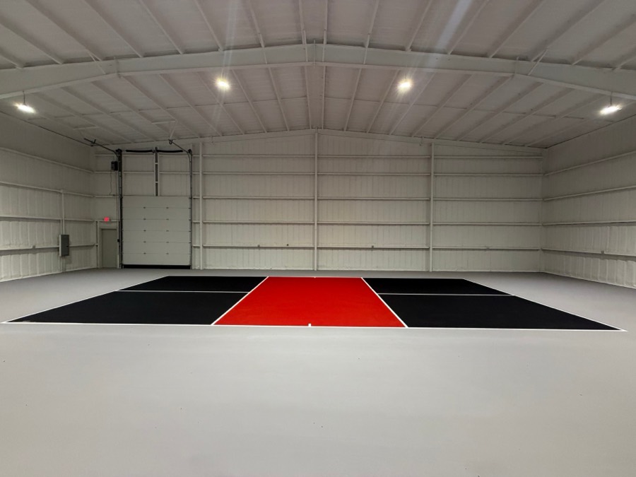Indoor black and red pickleball court