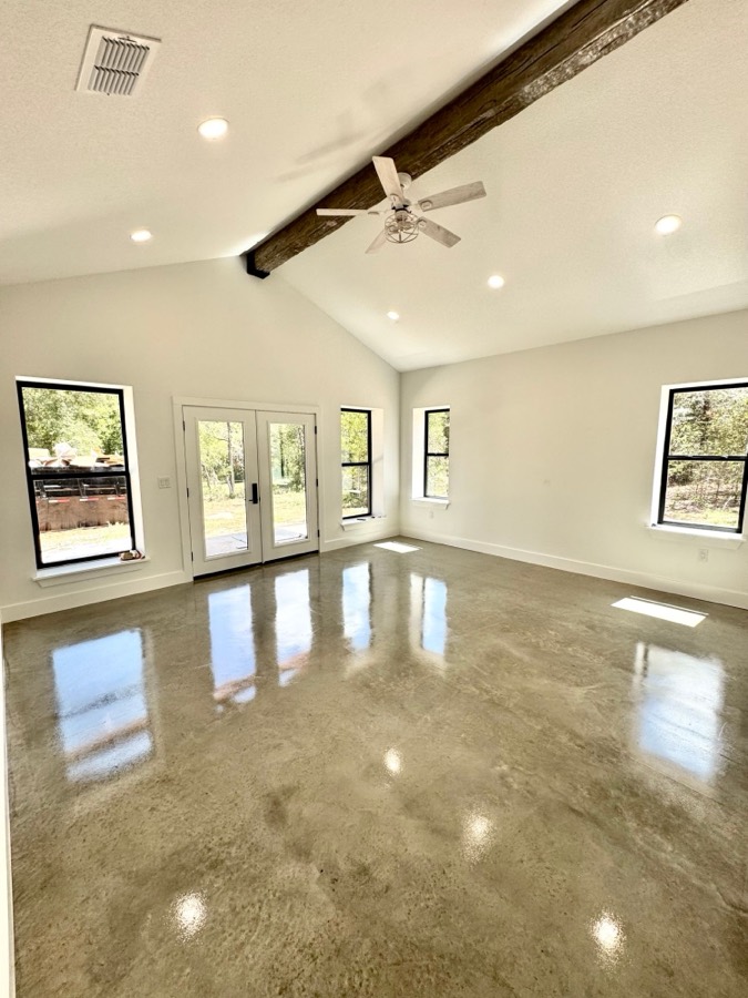 Stained and sealed concrete floor under a vaulted ceiling