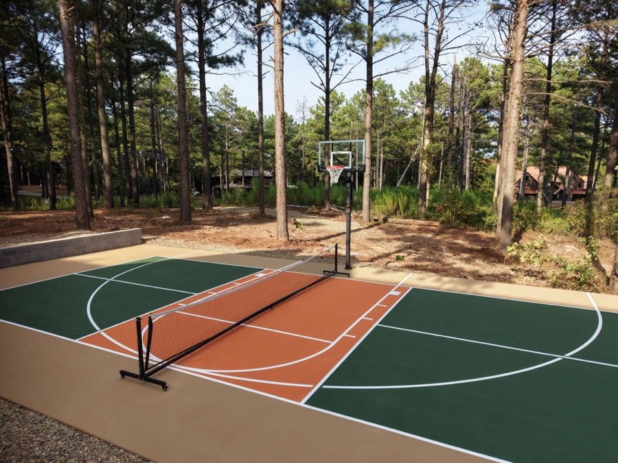 Green and terracotta pickleball court in the pines