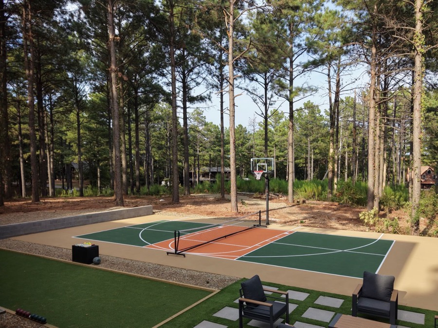 Green and terracotta court next to a turf yard